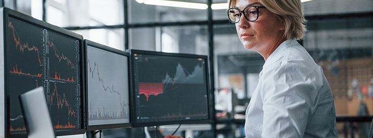 Female stockbroker in formal clothes works in the office with financial market.