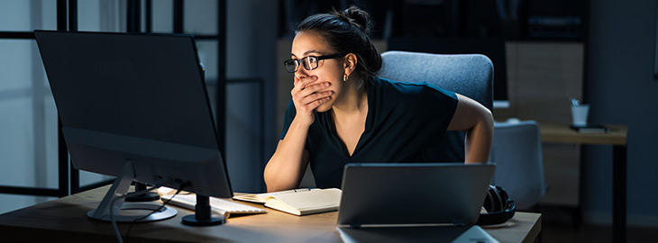 young lady looking devastated as she witnesses a cyber security data breach on her computer