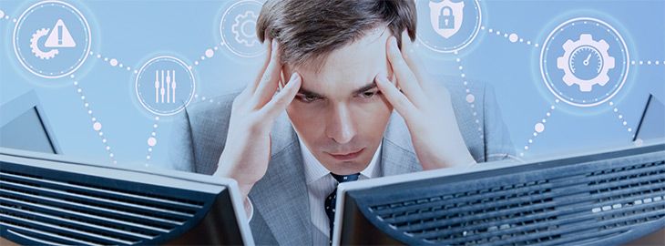 businessman looking worried at computer monitors