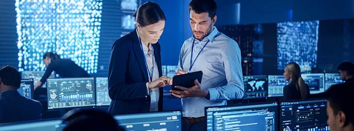 Project Manager and Computer Science Engineer Talking while Using A Digital Tablet Computer.