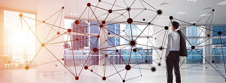 businessman standing in office surrounded by network nodes